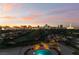 Stunning aerial view of the pool and Las Vegas strip at dusk with colorful sunset at 3111 Bel Air Dr # 12E, Las Vegas, NV 89109