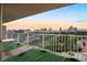 Balcony view overlooking a golf course and the iconic Las Vegas skyline at sunset at 3111 Bel Air Dr # 12E, Las Vegas, NV 89109