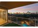 Balcony view showcasing the vibrant Las Vegas skyline at dusk and a glimpse of the community pool below at 3111 Bel Air Dr # 12E, Las Vegas, NV 89109