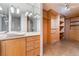 Bathroom featuring a dual vanity sink, vanity mirror and walk-in closet at 3111 Bel Air Dr # 12E, Las Vegas, NV 89109