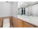 Bathroom featuring a glass vessel sink, tile backsplash, and natural wood cabinetry at 3111 Bel Air Dr # 12E, Las Vegas, NV 89109