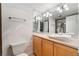 Bathroom with mirrored wall, decorative lighting, and vanity with unique sink and cream countertops at 3111 Bel Air Dr # 12E, Las Vegas, NV 89109