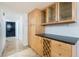 Butler's pantry offers storage with light wood cabinetry and sleek black countertops at 3111 Bel Air Dr # 12E, Las Vegas, NV 89109
