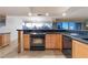 Eat-in kitchen featuring dark countertops, stainless appliances, and light wood cabinets at 3111 Bel Air Dr # 12E, Las Vegas, NV 89109