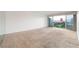 Spacious carpeted living room with sliding glass doors to balcony and views at 3111 Bel Air Dr # 12E, Las Vegas, NV 89109
