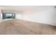 Large carpeted living room featuring floor to ceiling mirrors and balcony access at 3111 Bel Air Dr # 12E, Las Vegas, NV 89109