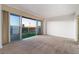 Bright living room featuring carpet floors and a large sliding glass door showcasing city views at 3111 Bel Air Dr # 12E, Las Vegas, NV 89109