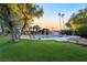 Inviting swimming pool area with lounge chairs, lush landscaping, and a charming clubhouse at 3111 Bel Air Dr # 12E, Las Vegas, NV 89109