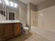 Bathroom with oak vanity, tub-shower combo, and tile flooring at 3388 Old Course St, Las Vegas, NV 89122