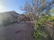 Charming home exterior with desert landscape, complemented by iron fencing and mature trees at 3388 Old Course St, Las Vegas, NV 89122