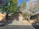 Charming single-story home featuring a spacious driveway and mature trees at 3388 Old Course St, Las Vegas, NV 89122