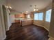 Open-concept kitchen and dining area with hardwood floors and oak cabinets at 3388 Old Course St, Las Vegas, NV 89122