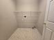 Laundry room with single wire rack shelf, neutral paint and tile floors at 3388 Old Course St, Las Vegas, NV 89122