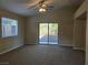 Bright, open living room with new carpet, vaulted ceiling, and a sliding door to the backyard at 3388 Old Course St, Las Vegas, NV 89122