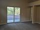Bright living room features new carpet, a sliding door and a view of the outdoor space at 3388 Old Course St, Las Vegas, NV 89122
