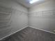 Carpeted walk-in closet with wire shelving and a fluorescent ceiling light at 3388 Old Course St, Las Vegas, NV 89122