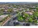 An elevated view of a neighborhood entrance with mature trees and beautifully kept landscaping at 3618 Auckland Castle St, Las Vegas, NV 89135