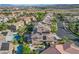 Scenic aerial view of a neighborhood with homes with pools and solar panels, mountain views at 3618 Auckland Castle St, Las Vegas, NV 89135