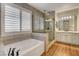 Bright bathroom with a soaking tub, glass-enclosed shower, and double vanity at 3618 Auckland Castle St, Las Vegas, NV 89135