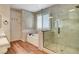Bathroom featuring a glass shower, soaking tub, shuttered window, and decorative tile at 3618 Auckland Castle St, Las Vegas, NV 89135