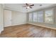 Comfortable bedroom with wood-look floors, ceiling fan, and shuttered windows at 3618 Auckland Castle St, Las Vegas, NV 89135
