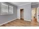 Bright bedroom featuring wood floors, base molding, and a closet with shuttered windows at 3618 Auckland Castle St, Las Vegas, NV 89135