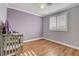 Bedroom featuring plantation shutters, wood flooring, and neutral walls at 3618 Auckland Castle St, Las Vegas, NV 89135