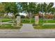 Entrance to Gardens Park, with stone pillars and well-manicured green spaces and benches at 3618 Auckland Castle St, Las Vegas, NV 89135