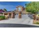 Beautiful stucco home featuring a three-car garage with stone accents and a tile roof at 3618 Auckland Castle St, Las Vegas, NV 89135