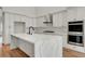 Spacious kitchen featuring a large quartz island, stainless steel appliances, and custom white cabinets at 3618 Auckland Castle St, Las Vegas, NV 89135
