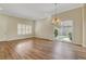 Bright living room with hardwood floors, chandelier, and a sliding glass door to the backyard at 3618 Auckland Castle St, Las Vegas, NV 89135