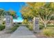 Stone pillars mark the entrance to the park, inviting residents to enjoy the green space and walking paths at 3618 Auckland Castle St, Las Vegas, NV 89135