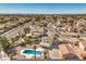 An elevated aerial view reveals a pool, mature palms, and neighborhood landscape with mountain views at 3708 Calumet Farm Cir, North Las Vegas, NV 89031
