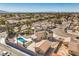 Aerial view of a home featuring a private pool, desert landscaping, and a detached garage in a residential neighborhood at 3708 Calumet Farm Cir, North Las Vegas, NV 89031