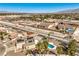 An aerial view of the property, featuring a pool, solar panels, and a well-maintained neighborhood at 3708 Calumet Farm Cir, North Las Vegas, NV 89031