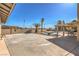 Large concrete patio area with covered space, mature palms, and a pool beyond at 3708 Calumet Farm Cir, North Las Vegas, NV 89031