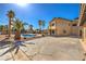 A spacious backyard featuring a pool, mature palm trees, and a covered patio area at 3708 Calumet Farm Cir, North Las Vegas, NV 89031
