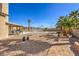 Landscaped backyard features a pool, covered patio, and mature palm trees at 3708 Calumet Farm Cir, North Las Vegas, NV 89031