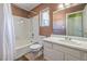 Clean bathroom featuring a shower-tub combo, a white vanity, and neutral wall tiles at 3708 Calumet Farm Cir, North Las Vegas, NV 89031