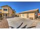 Rear view of a two-story house with a detached garage, featuring a large concrete patio area at 3708 Calumet Farm Cir, North Las Vegas, NV 89031