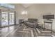 Bright living room with herringbone floors, a modern fireplace, and french doors opening to the backyard at 3708 Calumet Farm Cir, North Las Vegas, NV 89031