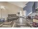 Spacious living room featuring vaulted ceilings, and wood-look herringbone flooring, complemented by modern decor at 3708 Calumet Farm Cir, North Las Vegas, NV 89031