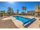 Sparkling swimming pool with a safety cover, set in a well-maintained backyard with mature landscaping at 3708 Calumet Farm Cir, North Las Vegas, NV 89031