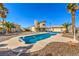 Inviting backyard featuring a private pool, palm trees, and desert landscaping, perfect for outdoor living at 3708 Calumet Farm Cir, North Las Vegas, NV 89031