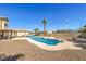 Backyard pool with mature palm trees and patio with outdoor seating at 3708 Calumet Farm Cir, North Las Vegas, NV 89031