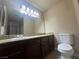 Bathroom features a large vanity with dark wood cabinets and a marble-look countertop at 4050 Pacific Harbors Dr # 217, Las Vegas, NV 89121
