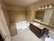 Bathroom features a bathtub, shower, and vanity with dark wood cabinets at 4050 Pacific Harbors Dr # 217, Las Vegas, NV 89121