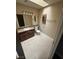 Bathroom features tile floors, a skylight, and a vanity with dark wood cabinets at 4050 Pacific Harbors Dr # 217, Las Vegas, NV 89121