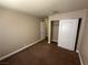 This bedroom features neutral carpet and a closet with white doors at 4050 Pacific Harbors Dr # 217, Las Vegas, NV 89121