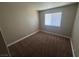 This bedroom features neutral carpet, fresh paint, and a window at 4050 Pacific Harbors Dr # 217, Las Vegas, NV 89121